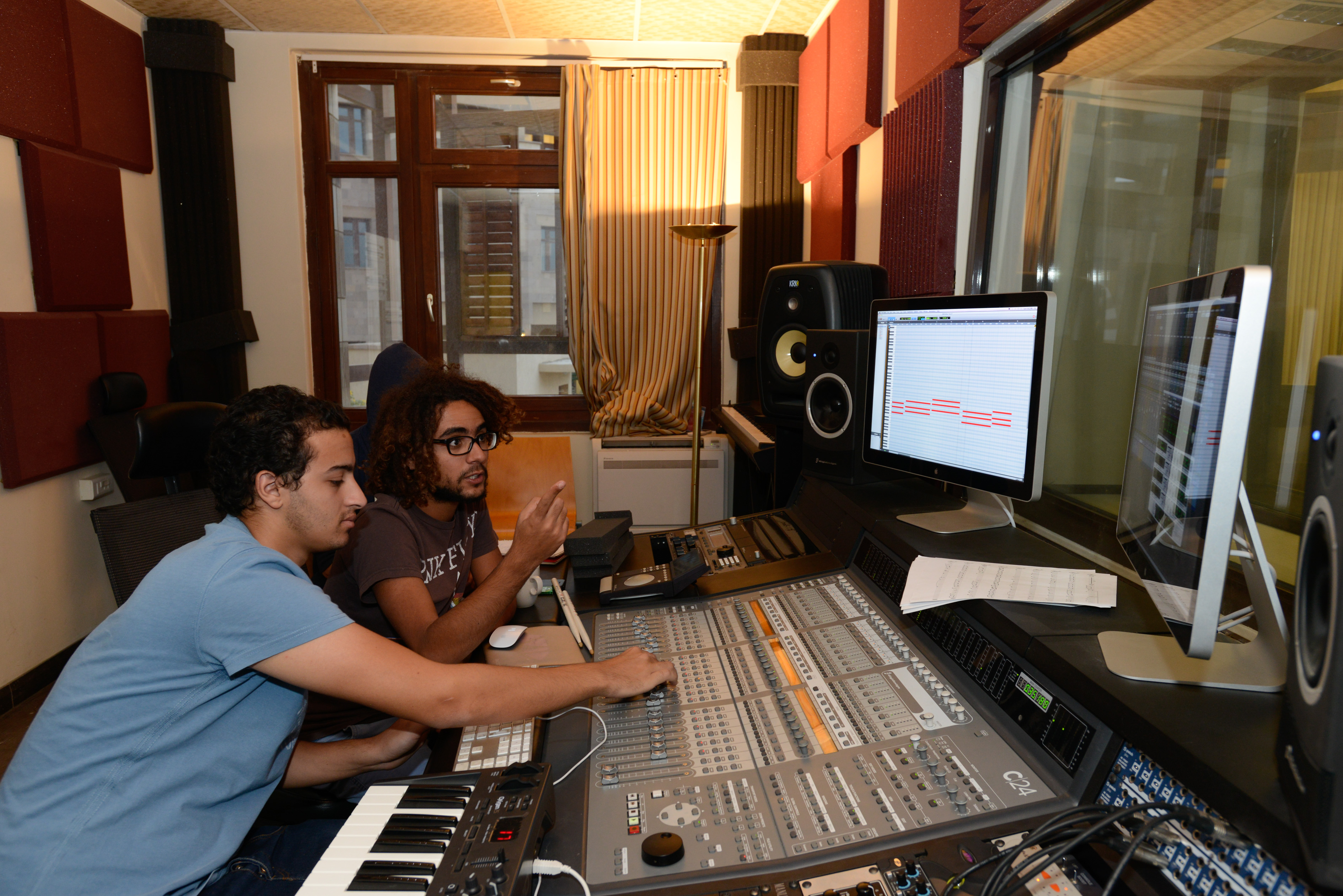 students working music studios with digital and mixing equipment