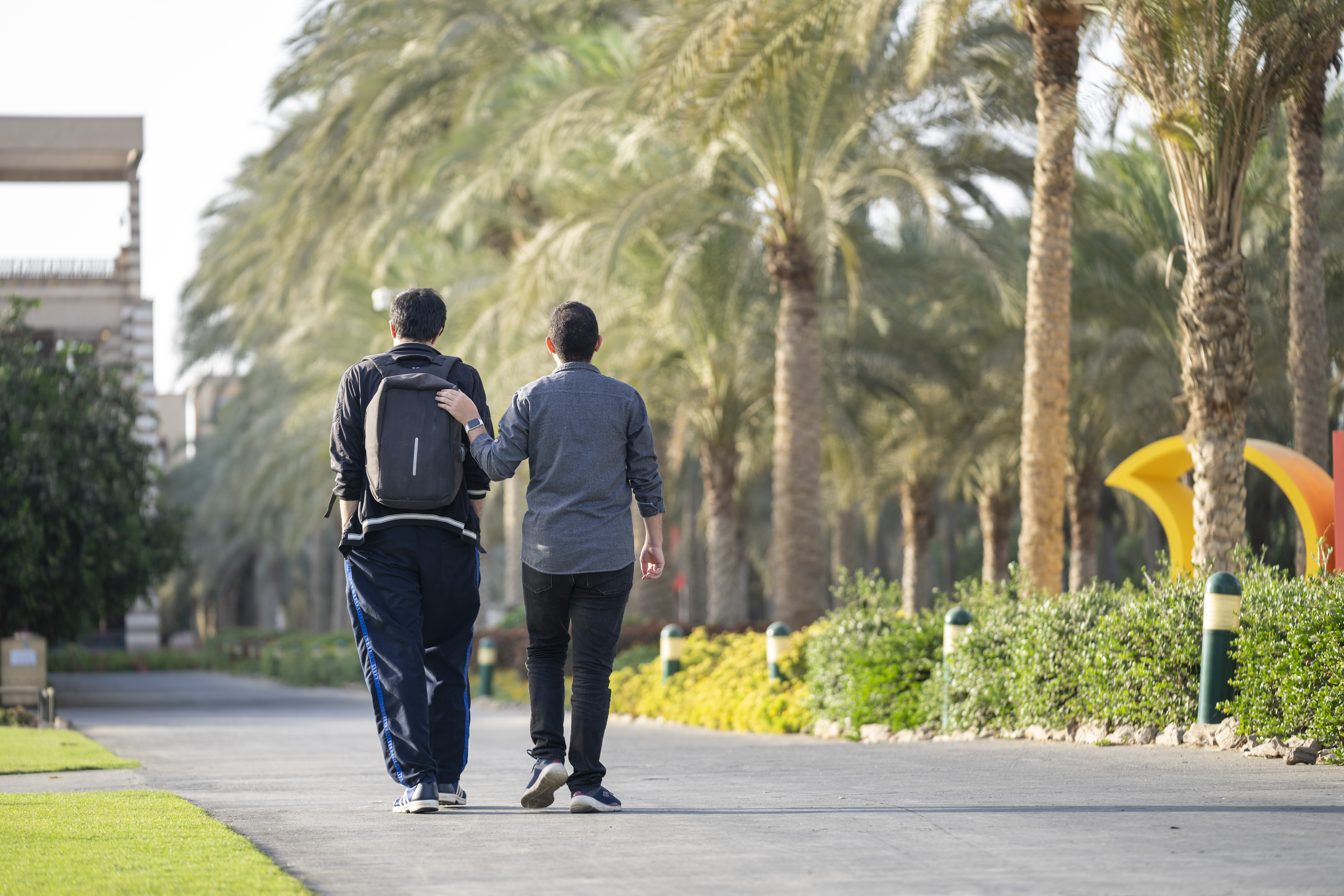 students walking in AUC New Cairo garden 