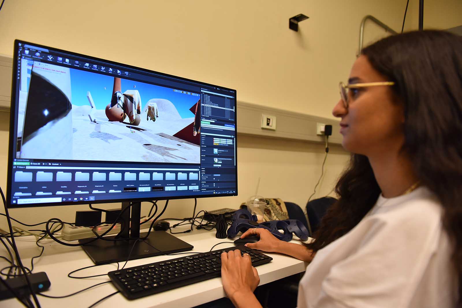 female student using a computer and creating graphics with software