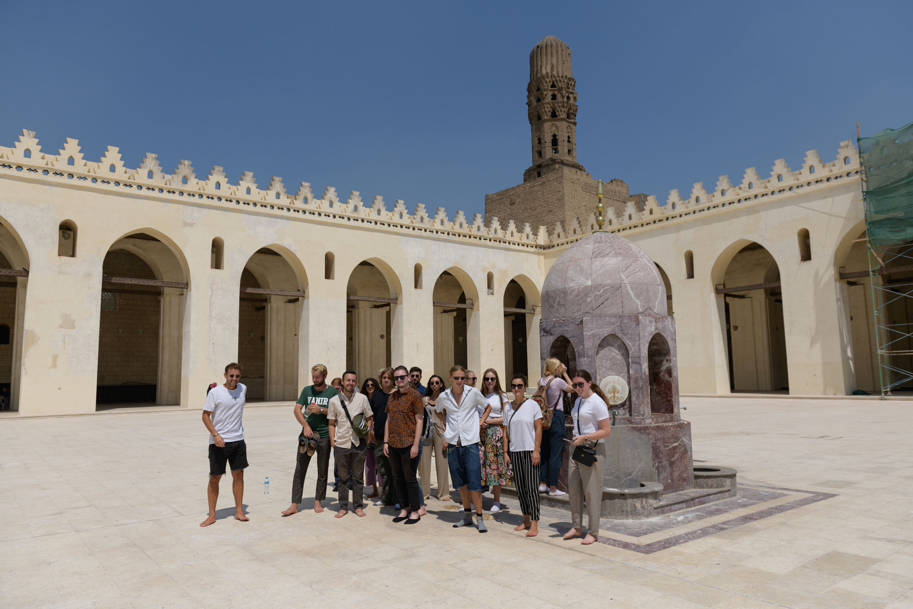 A group of international students standing in a mosque outdoors