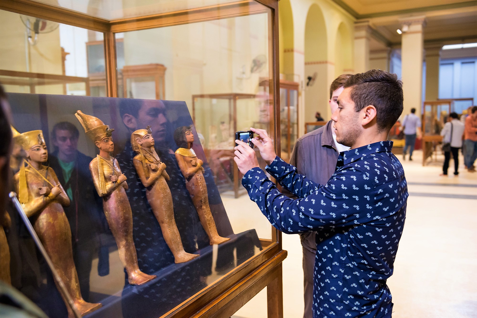 a tourist taking a photo inside the egyptian museum
