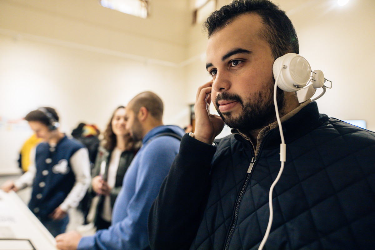 student in exhibition with headphones