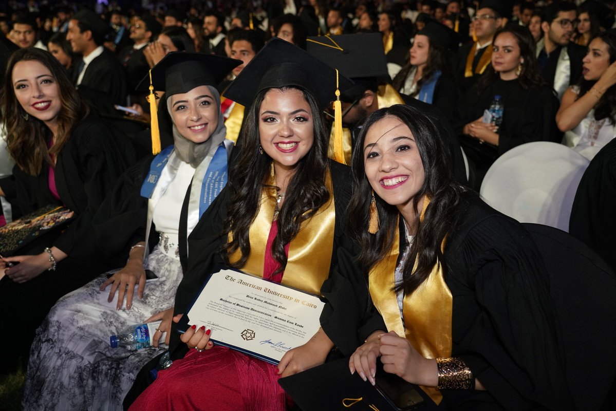 students wearing cap and gown in commencement