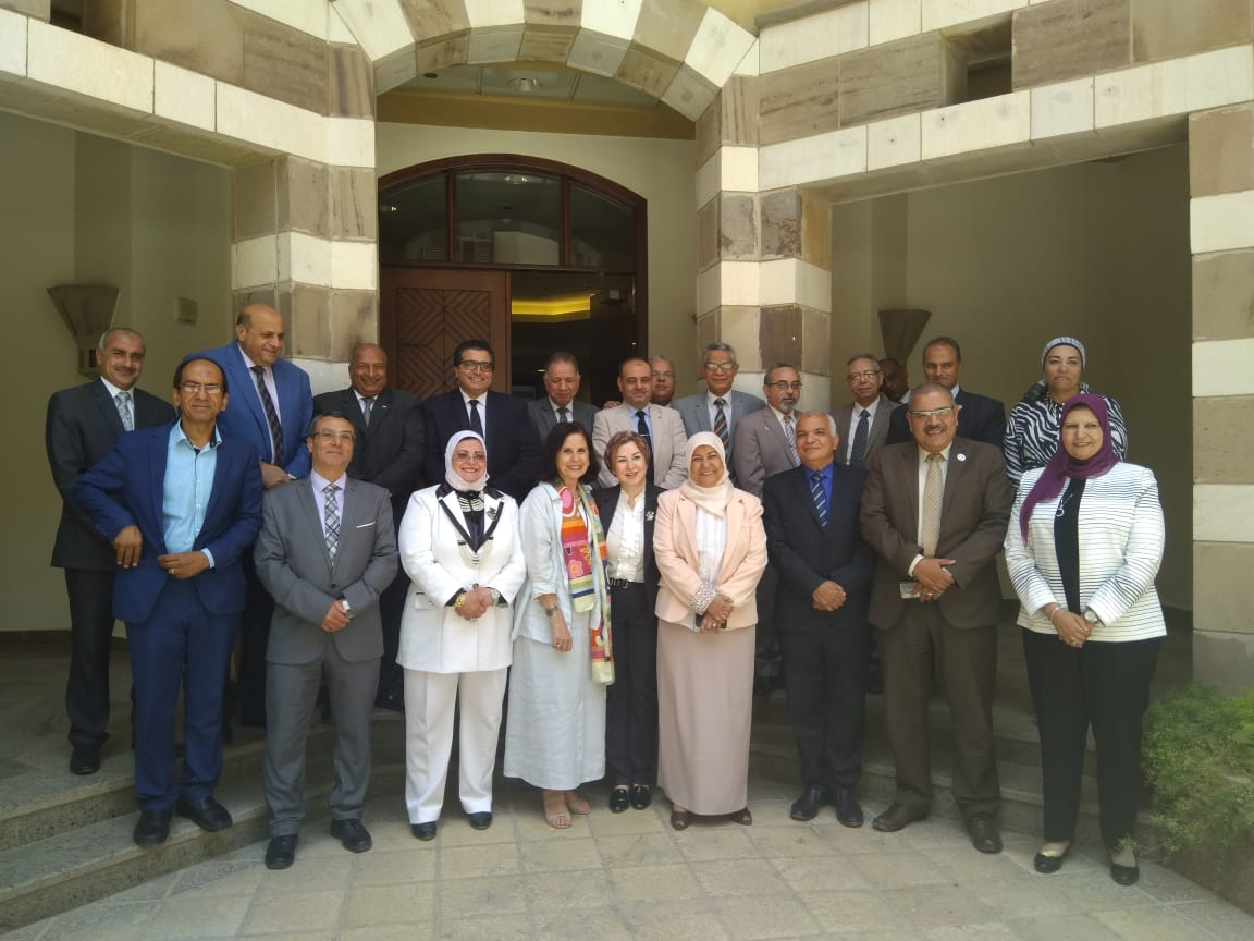 A group photo of the MEIHEI members with the AUC campus in the background