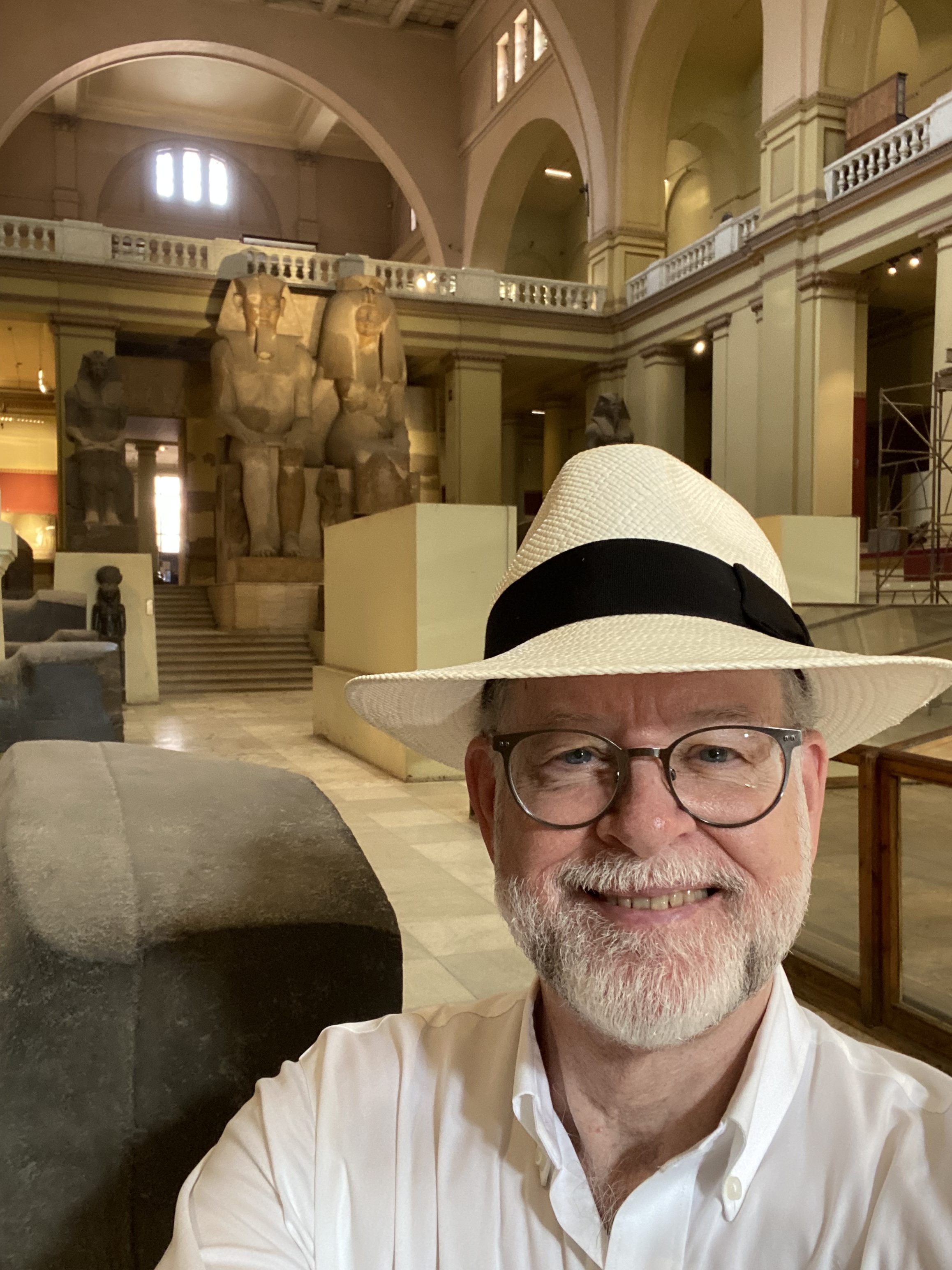 Headshot of a man smiling in a museum
