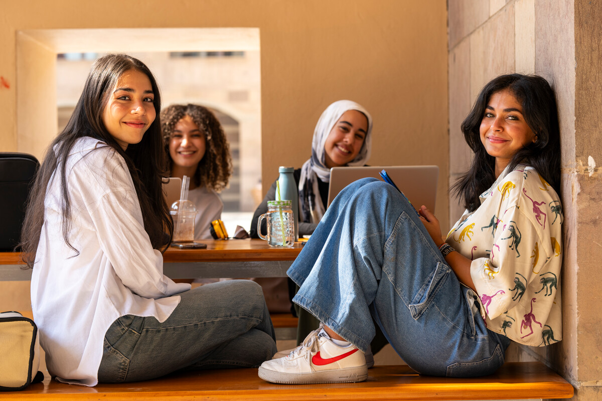 group of students in hanging around campus interacting with peers