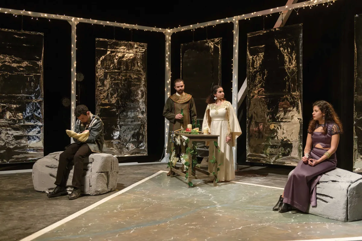Students performing on stage in theatre production