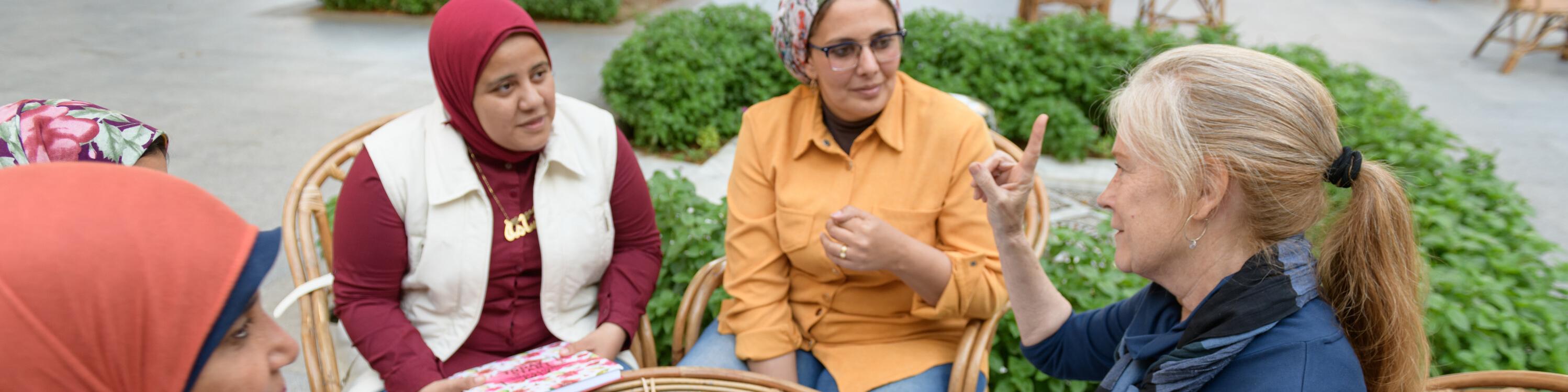 professor explaining a topic to graduate students outdoors