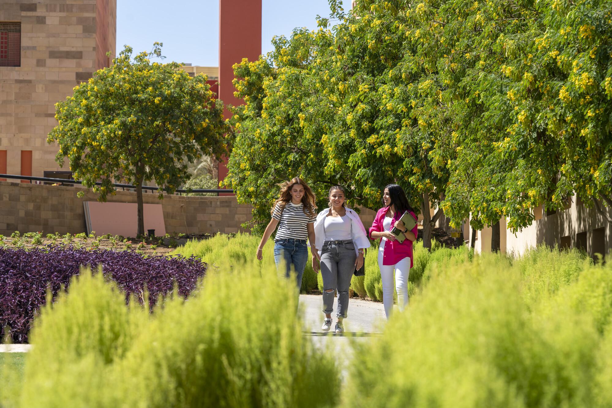 students walking on campus in the gardens