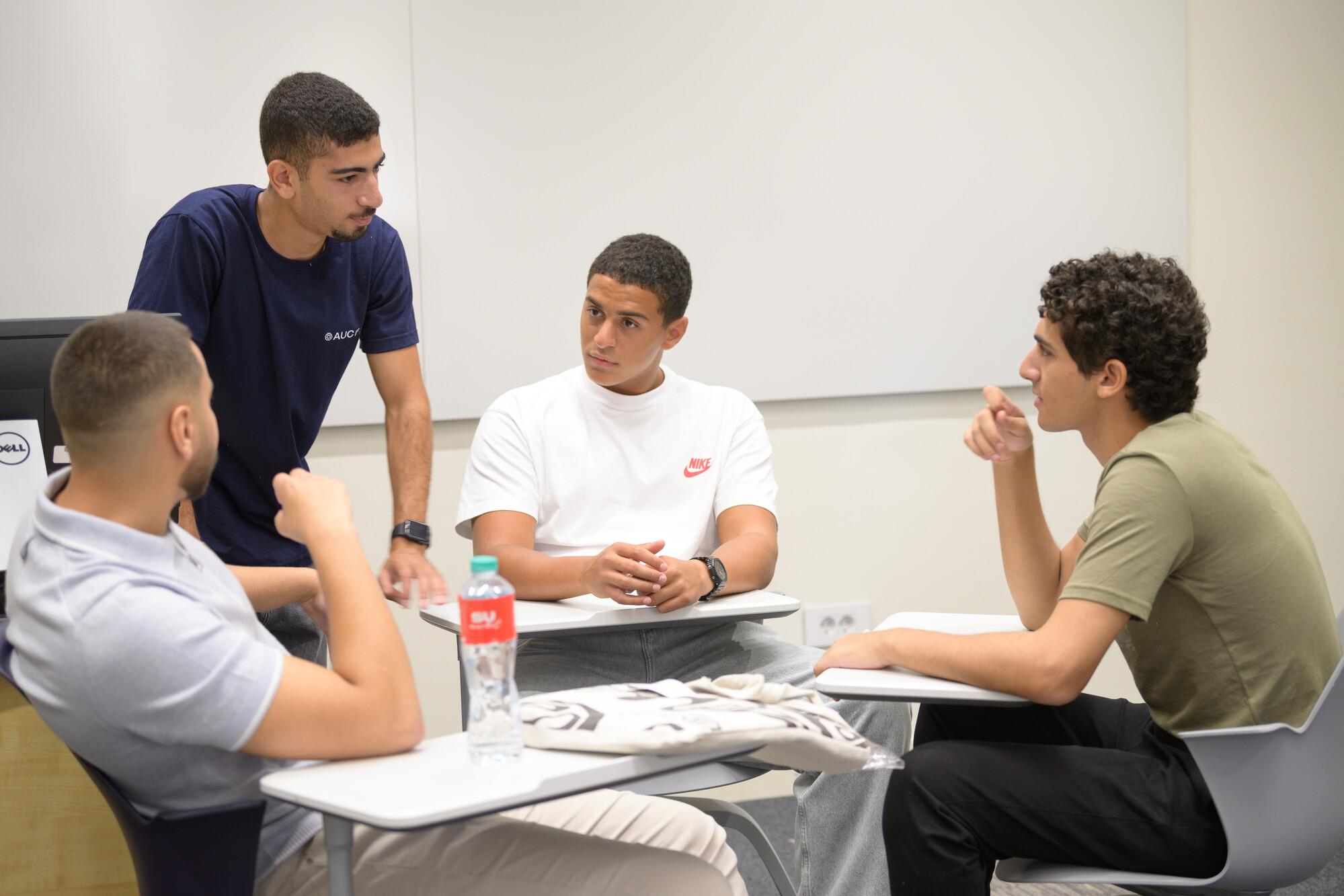 group of male of students in class in group discussion