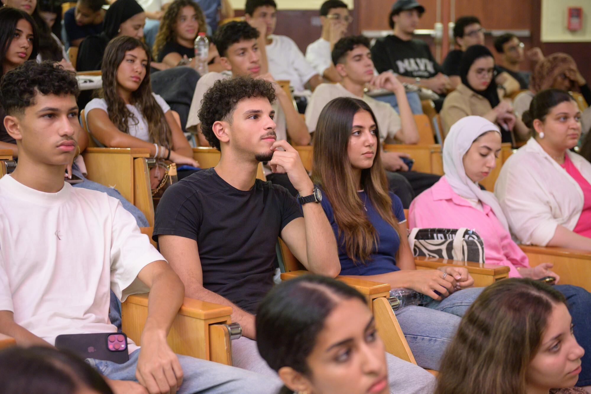 students in hall listening to information during orientation