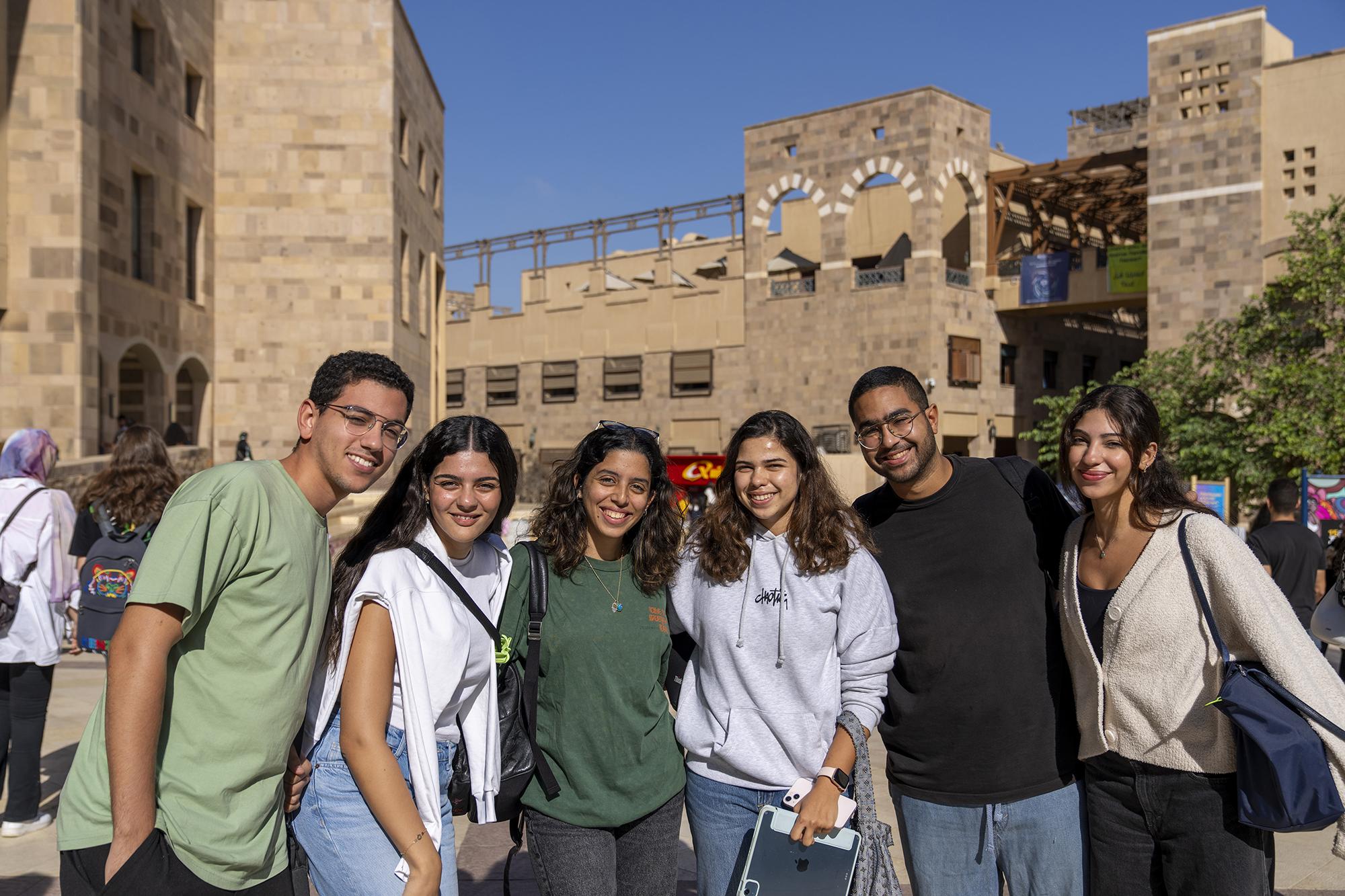 group of smiling students going to class