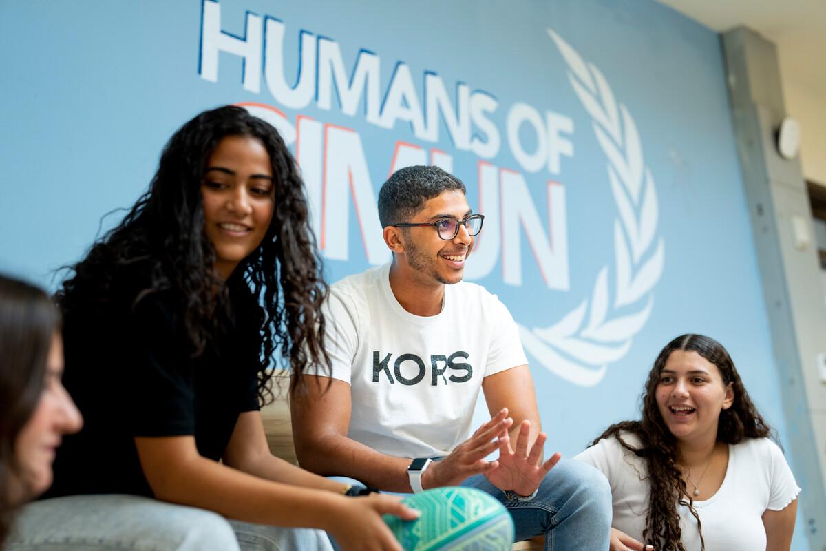 students in a group talking in the CIMUN hub