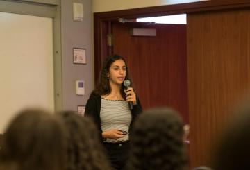 young woman speaking to an audience