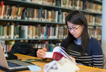Student reading in a library