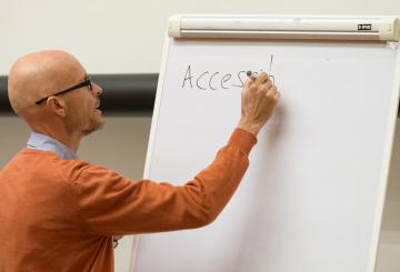 A professor writing on the board