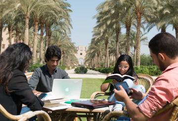 Students studying outdoors on campus