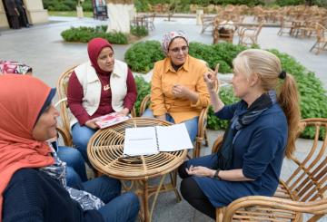Psychology Graduate students with professor in garden explaining