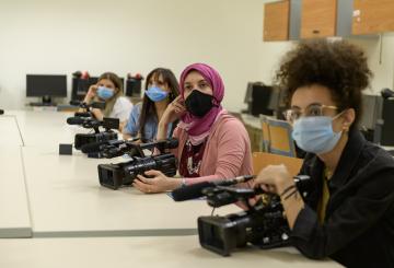 students learning to use cameras in class room