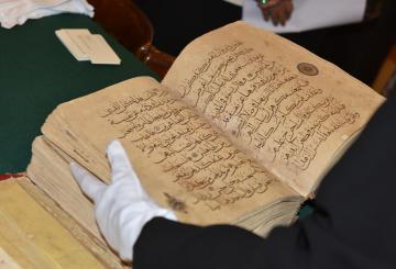 close up of opened old book in Arabic writing