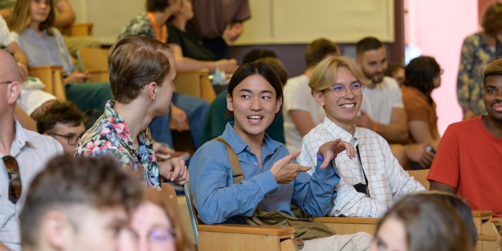 smiling students talking in hall 