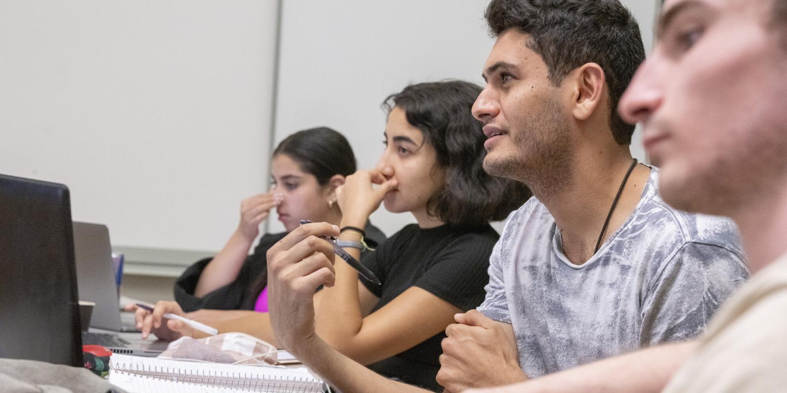 students writing in classes and taking notes