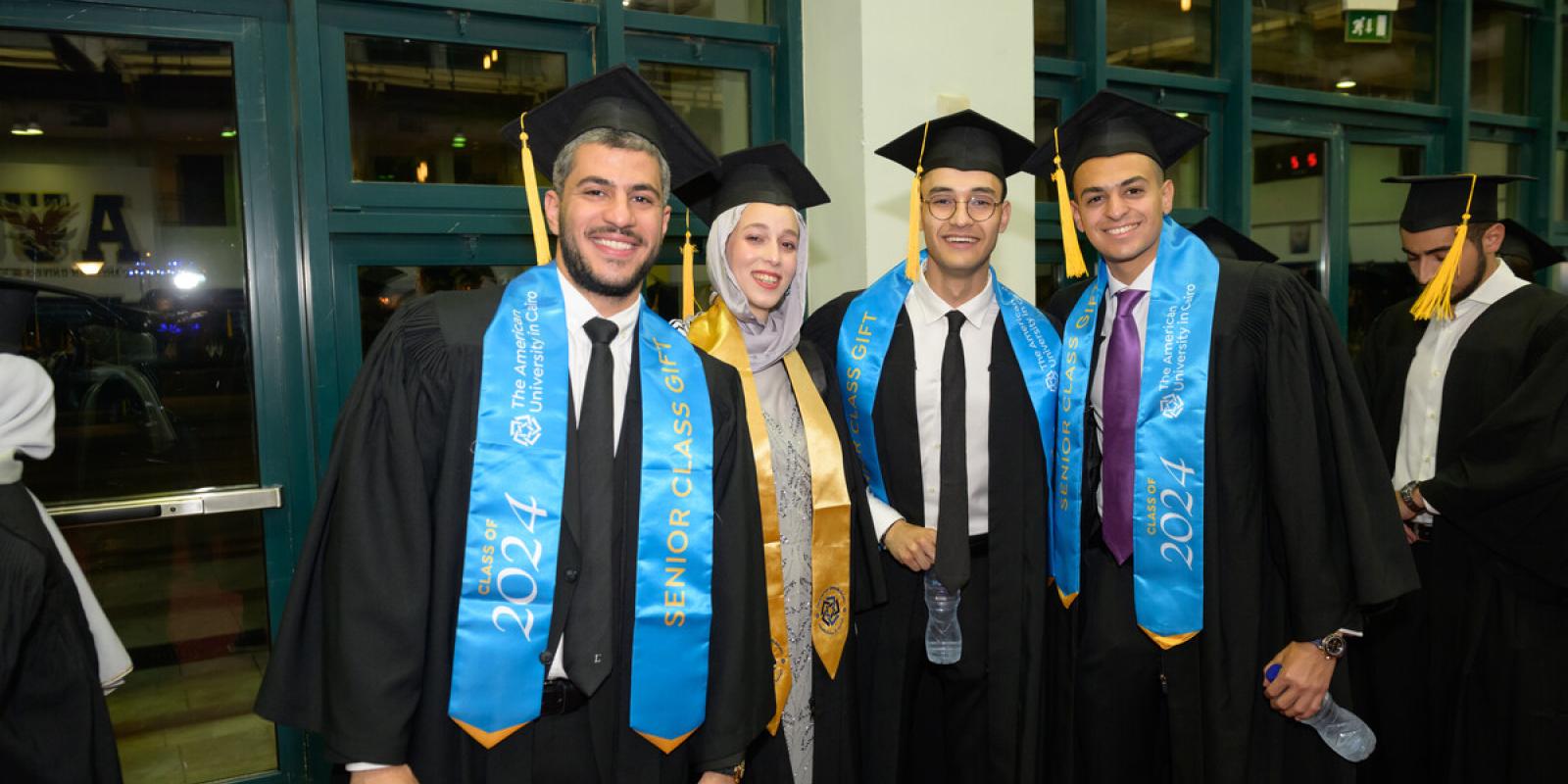 graduating students wearing cap and gown at the commencement