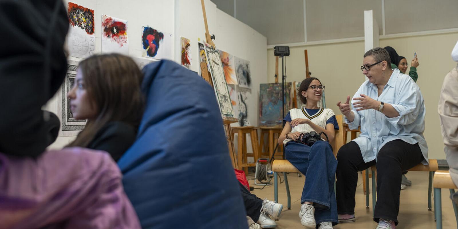professor working with student in art studio