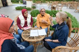 Psychology Graduate students with professor in garden explaining 