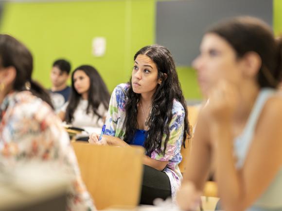 students writing in classroom and taking notes