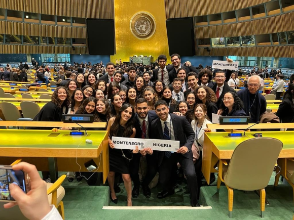 A large group of girls and boys taking a picture with a certificate