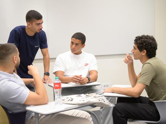 group of male of students in class in group discussion