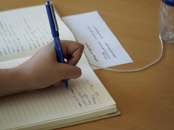 writing in a note book in arabic 