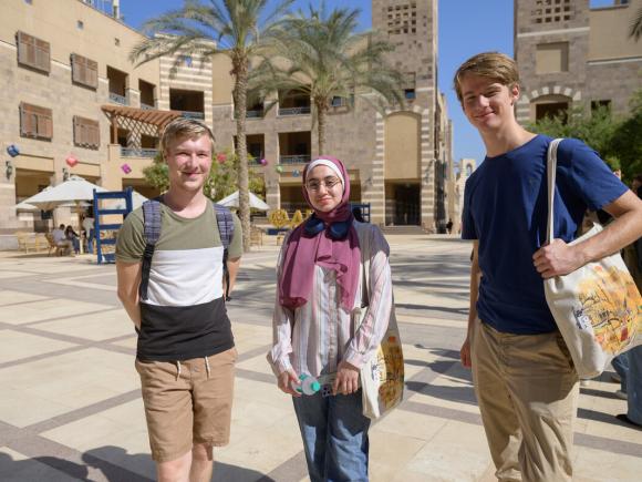 international students walking on campus going to class