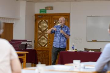 a professor holding the microphone