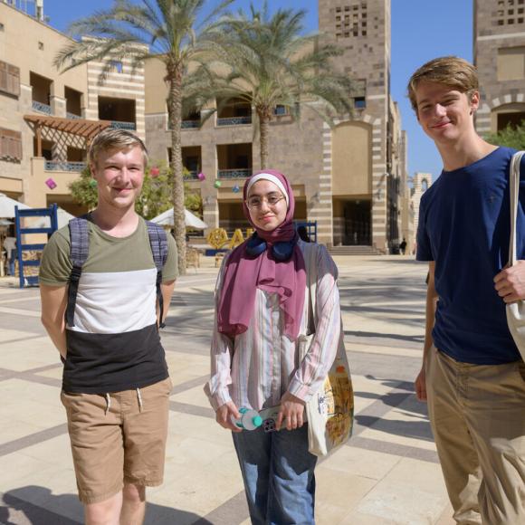 international students walking on campus going to class