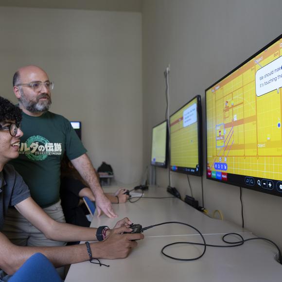 professor working with student on gaming 